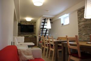 a kitchen and dining room with a table and chairs at Apartmány Mamut Harrachov in Harrachov