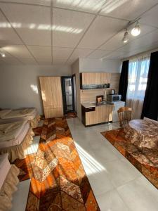 una camera con due letti e un tavolo e una cucina di Apartments EMIZA a Samokov