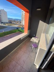 a balcony with a table and a chair at Apartments EMIZA in Samokov