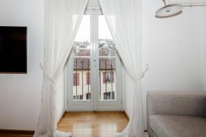 TV a/nebo společenská místnost v ubytování A Casa Nuccia Mansarda by Holiday Solutions