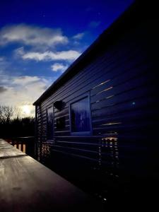 a building with two windows on the side of it at JS Holidays Tebay Lagganhouse in Ballantrae