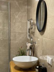 a bathroom with a white sink and a mirror at Südalinna apartment in Kuressaare