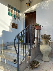 a staircase with a vase on the side of a building at Villa Franca in Reggio Calabria