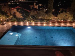 a swimming pool at night with lights at Borgata Cantone Country House B&B in Garlenda