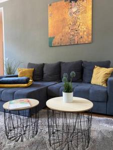 1 sofá azul con 2 mesas en la sala de estar en AKK4 - Apartment MD Zentrum nähe Uni und Hbf, en Magdeburgo