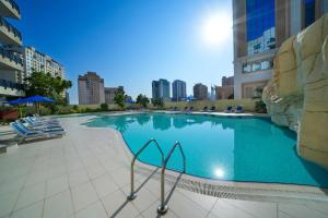 a large swimming pool in the middle of a building at Park Apartments Dubai, an Edge By Rotana Hotel in Dubai