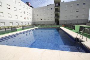 a swimming pool on the roof of a building at Lovely Apartment Sevilla Azahar Parking in Bormujos