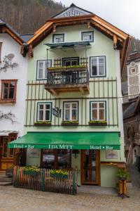 a large white building with a balcony on it at I da Mitt in Hallstatt