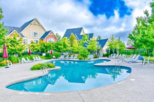 a swimming pool in a resort with chairs and trees at Rivergrass 226 in Blue Mountains