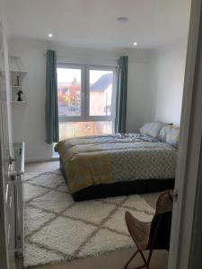 a bedroom with a bed and a large window at Beautiful 1-Bed Apartment in Redhill in Redhill