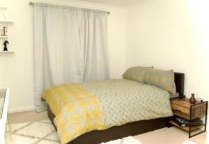 a bedroom with a bed and a window at Beautiful 1-Bed Apartment in Redhill in Redhill