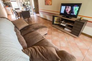 a living room with a couch and a flat screen tv at La Croix du Sud 1 in Cilaos