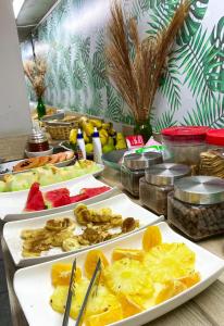un buffet composé de plusieurs assiettes de fruits sur une table dans l'établissement Pousada Barra Bonita, à Bonito
