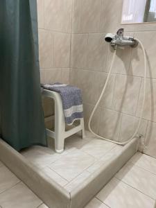 a shower with a shower curtain and a sink in a bathroom at Feidiou 1, vol I in Aegina Town