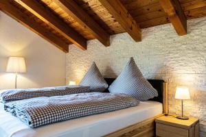 a bedroom with a bed with two pillows on it at Himmelseck in Oberstaufen
