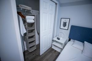 a small room with a bed and a closet at The Contemporary in Sanford