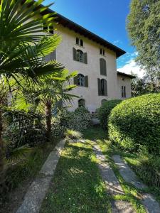 a house with a palm tree in front of it at Appartamento in Villa Storica in Oleggio Castello