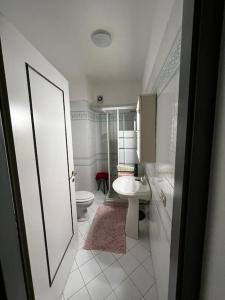 a bathroom with a white toilet and a sink at Appartamento in Villa Storica in Oleggio Castello