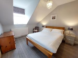 a bedroom with a large white bed and a window at Ashleigh House - Room Only in Windermere