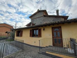 a house with a fence in front of it at La Casa del Nonno in Porano