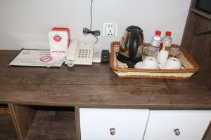 a counter top with a telephone and items on it at Ostro Hotel in Phnom Penh