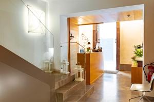 a living room with a staircase and a chair at Hotel P&aacute;rraga Siete in Granada