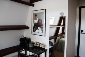 a room with a staircase and a shelf with cupcakes at Hotel Dwars in Amsterdam