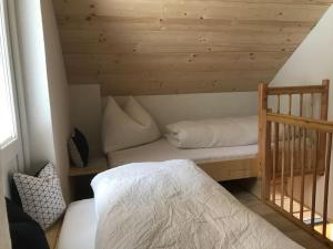 a small bedroom with a bed and a staircase at Chalet Schröder in Klippitztorl
