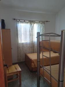 a room with two bunk beds and a window at Sierras Del Sol in Villa Carlos Paz