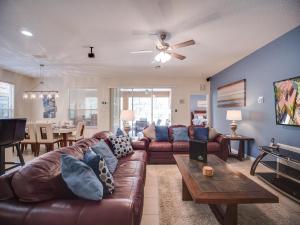 a living room with a couch and a table at Casa Amore at Ellis Exclusive Villas in Davenport