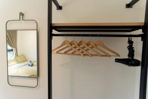 a closet with hangers and a mirror next to a bed at 2R2B Lost World of Tambun Sunway Onsen Nara Suite in Ipoh