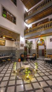 a large room with a table in a building at Riad Green House in Fez