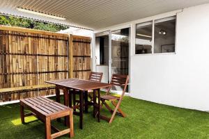 a wooden table and two chairs on a patio at Studio C by Breckler Park in Perth