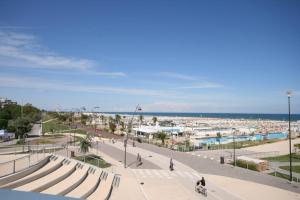 een uitzicht op een stad met wandelende mensen en een strand bij Hotel Globus in Rimini
