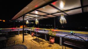 a restaurant with a view of the water at night at Riad Green House in Fès