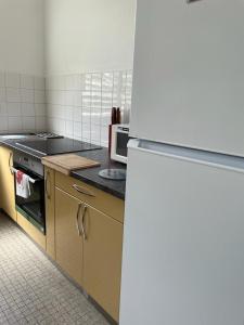 a kitchen with a stove and a microwave at KAZ A FAUP in Grand-Bourg