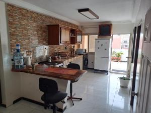a kitchen with a table and chairs and a refrigerator at Casa Djoko in Dakar