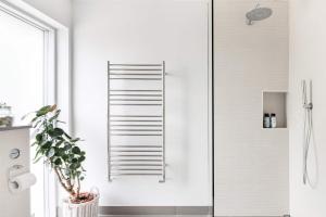 a shower with a glass door in a bathroom at The Oaks, Twyford Moors, South Downs National Park in Winchester