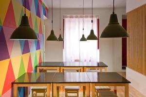 蓬塔德爾加達的住宿－Azorean Urban Lodge，一间设有桌子和多彩墙壁的用餐室