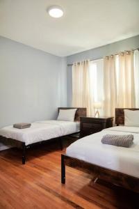 two beds in a room with wooden floors at Cozy apartment 1st 10min Walk Downtown and City View in Providence