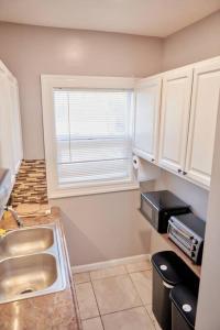 a small kitchen with a sink and a window at Cozy apartment 1st 10min Walk Downtown and City View in Providence