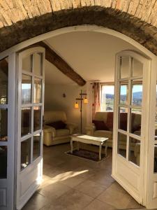 an archway in a living room with a couch and a table at L'Arbre d'Alice in Ongles +44 photos