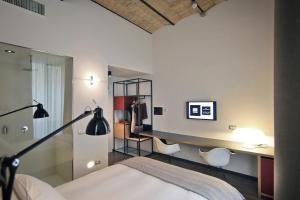 een slaapkamer met een bed, een bureau en stoelen bij Atypical Rooms in Rome
