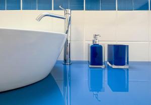 a bathroom with a sink and a tub and a sink at Nelinda Waterfront Accommodation in Ischia