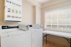 a room with a white counter and a window at Hometown Inn & Suites Jacksonville Butler Blvd./Southpoint in Jacksonville +5 photos