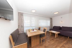 a living room with a table and chairs and a couch at Stöcklhof in Pettneu am Arlberg