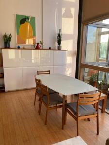 a dining room with a table and chairs at Loft in Haggerston in London