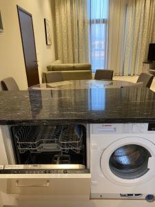 a washer and dryer in a living room at Hawana Palm Beach in Salalah