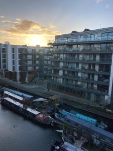 a large building with boats docked next to a river at Loft in Haggerston in London