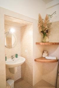 a bathroom with a sink and a mirror at Antiche Dimore TerraRossa in Alberobello